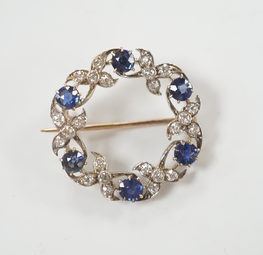 A yellow and white metal, sapphire and diamond cluster set openwork brooch, 24mm, gross weight 4.6 grams.